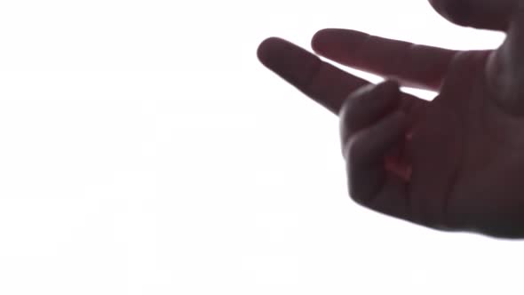 Person does hand gesture with bright white backdrop 7 alt