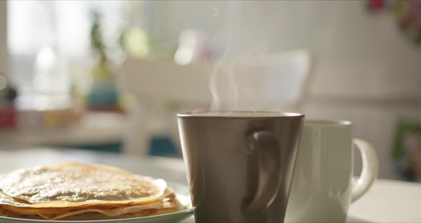 Woman Preparing for Breakfast Takes a Fresh Pancake From Plate alt