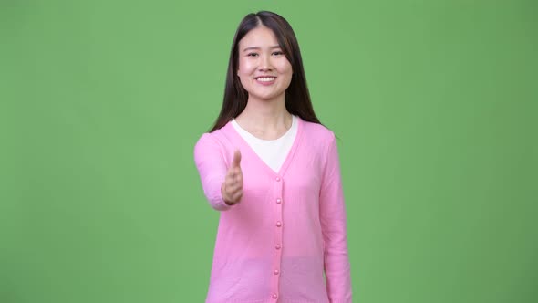 Young Beautiful Asian Woman Giving Handshake