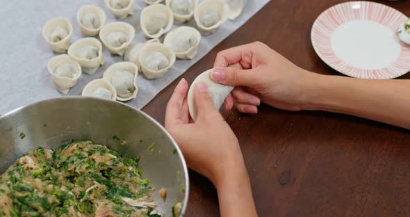 Woman make of chinese meat dumpling at home