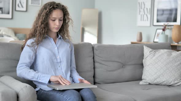 Curly Hair Woman Coming, Sitting and Starting Work on Laptop alt