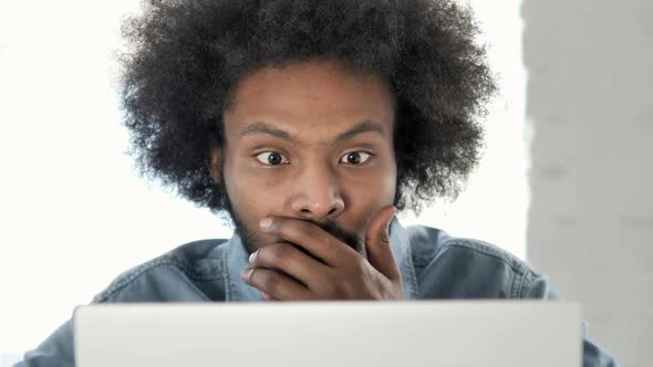 Close Up of Creative African Man in Shock at Work alt
