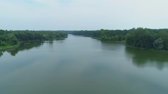 Aerial View Beautiful Nature Forest and Lake in Which Fisherman is Fishing alt