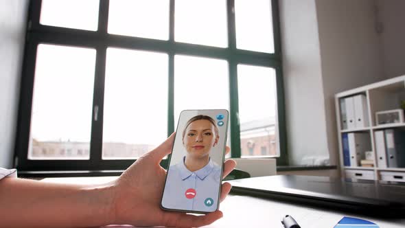 Hand Holding Smartphone with Video Call at Office