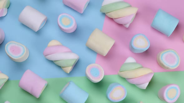 Rotating Multicolored Chewy Marshmallows on a Multicolored Background the Concept of a Birthday