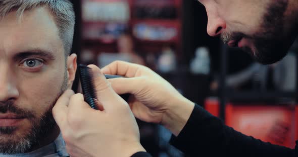 Barber Cuts the Beard To the Client with a Hair Clipper. Brutal Barbershop alt