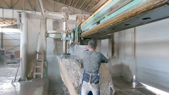 A Worker Cuts Stone Details at the Factory