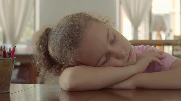 Closeup Face of a Little Girl Sleeping Baby on Her Side in Her Arms alt