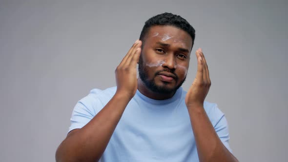 Happy African American Man Applying Cream To Face alt
