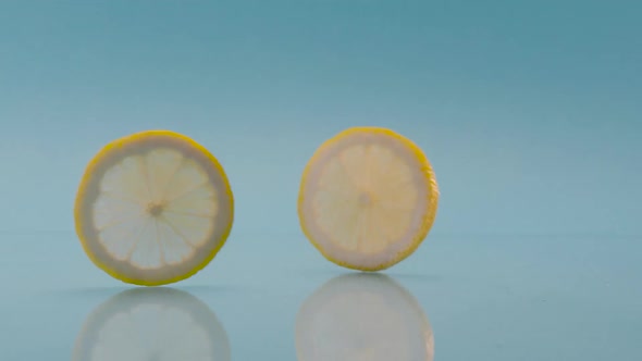 Creative Lemon Slices Running on Blue Background for Fresh Summer Lime Cocktail alt