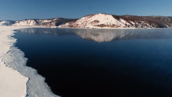 Aerial View of Ice on Steamy River Lake. Russia Siberia Baikal Freshwater Freezing or Melting.