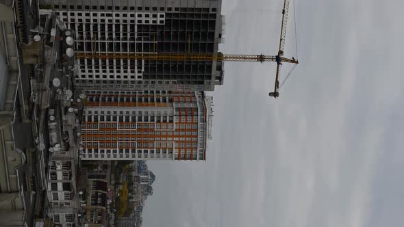 Unfinished building with construction crane jib time lapse