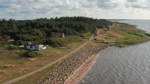 Family Walking on Pathway Along Sea Coast alt