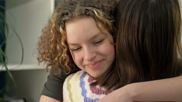 Teenage Girl Happily Hugs Her Mom or Girlfriend alt