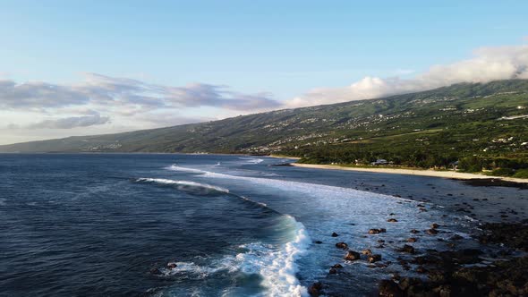 Drone footage of waves at the beach at the Reunion island during sunset. alt