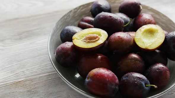 Bowl of Fresh Plums in Daylight alt