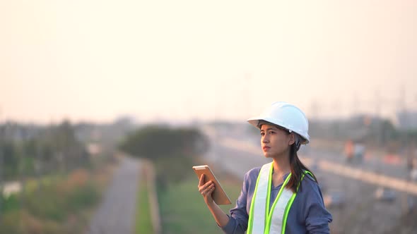 Female civil Engineering working with tablet on bridge highway