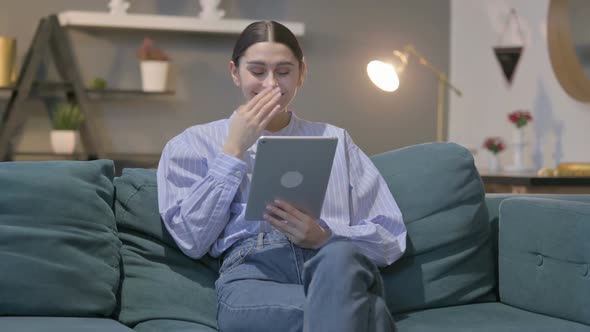 Hispanic Woman Talking on Video Call on Tablet on Sofa alt