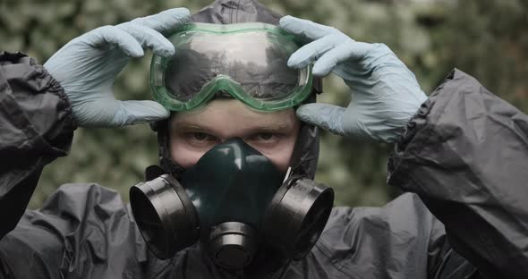 Man in Chemical Protection Suit Respirator and Glasses Closeup