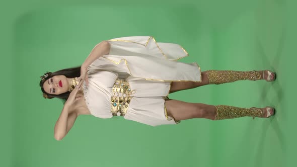 Beautiful Woman in Greek Greece Goddes Dress and Wreath High Fashion. Green Screen. Vertical Video. alt