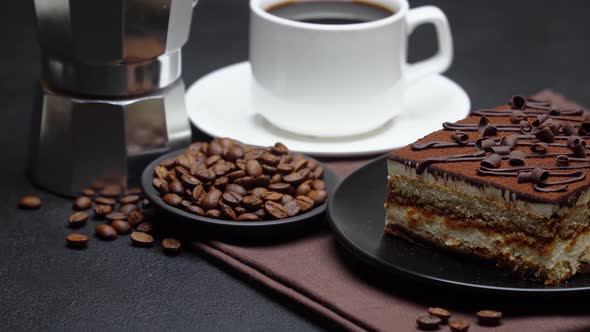 Portion of Traditional Italian Tiramisu dessert, mocha coffee maker, cup of espresso alt