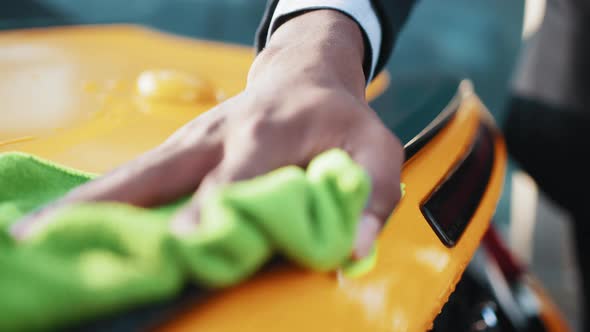 A Man Wipes Moisture and Stains From His Car with a Special Rag alt