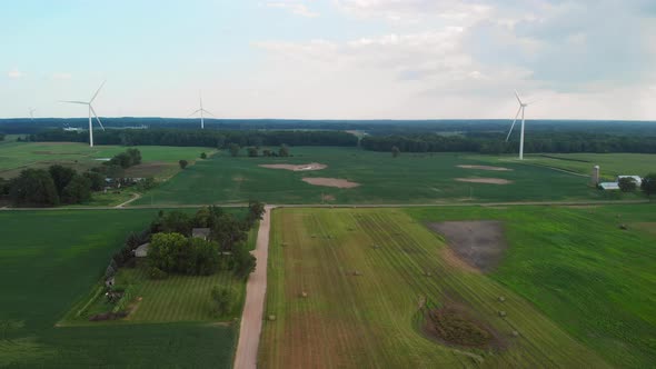 Aerial View Of Rural Area With Farm Fields And Wind Mills.