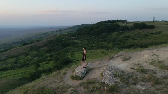 Camera Swirls Around a Woman in a Hat and Black Dress alt