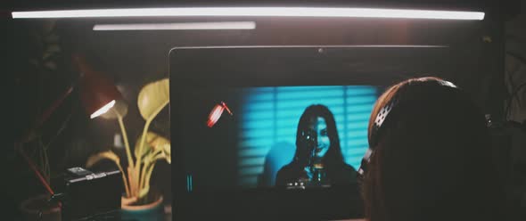 A woman working on movie clip on her computer alt