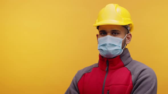 Portrait of Young Indian Man with Face Mask and Yellow Helmet Nodding ...