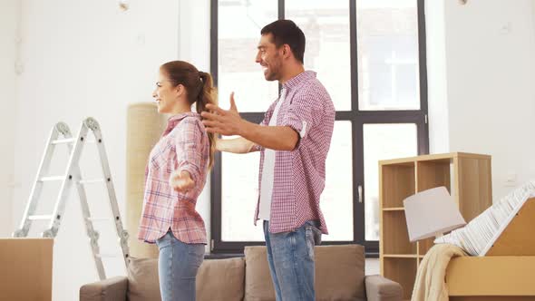 Happy Couple Moving To New Home and Hugging alt