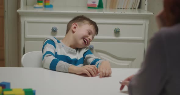 Autistic Boy Learning with Applied Behavior Analysis Therapist alt