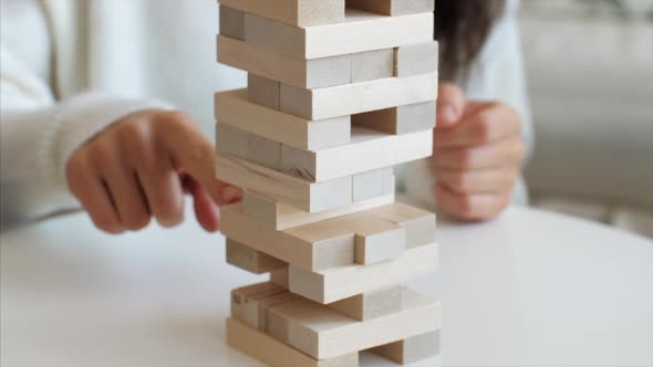 Family is Playing in Wooden Tower at Home