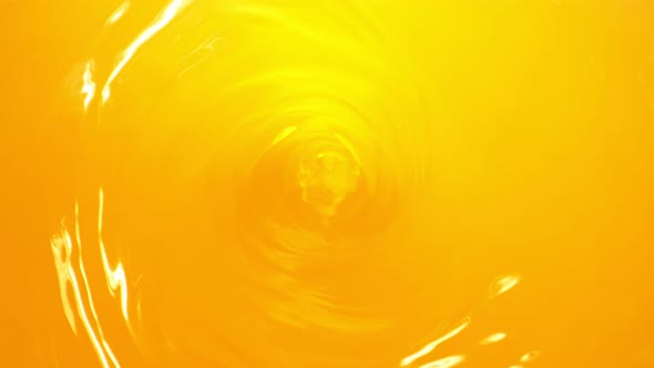 Super Slow Motion Shot of Orange Juice Whirl at 1000 Fps alt