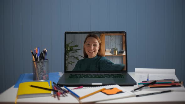 A Young Woman is Talking Through a Video Call alt