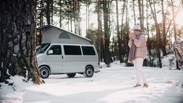 Romantic Couple Resting in the Woods on Sunny Winter Day Enjoying Van Life