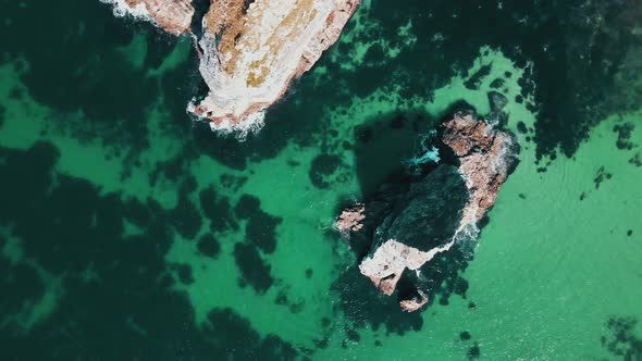 Lonely rock in blue clear water. Aerial view.