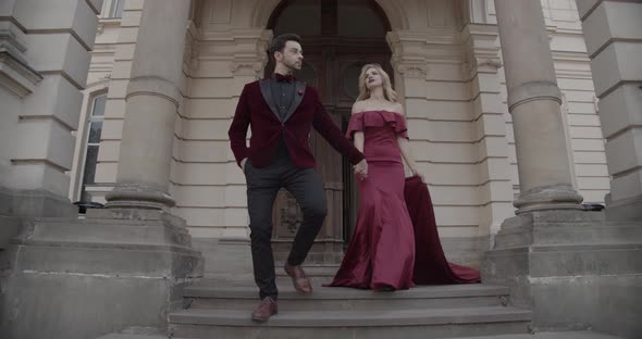 Girl In A Long Evening Dress With A Guy In A Festive Costume Came Out Of The Ancient Castle alt