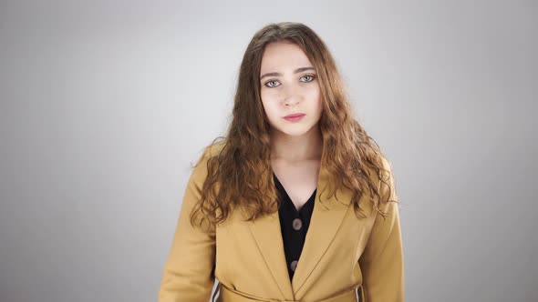 Isolated Portrait of an Angry Woman Threatening By Showing Fist on a White Background alt