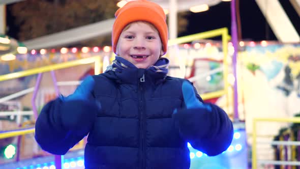 Boy with milk tooth gap is very happy at the Christmas market
