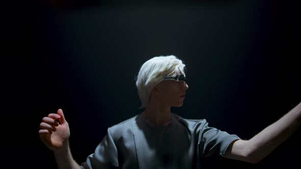 Gamer Wearing Virtual Goggles in Futuristic Light alt