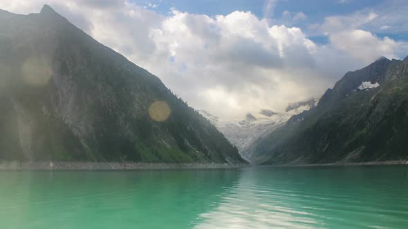 Time Lapse Clouds Move Above Reservoir in Austrian Alps alt