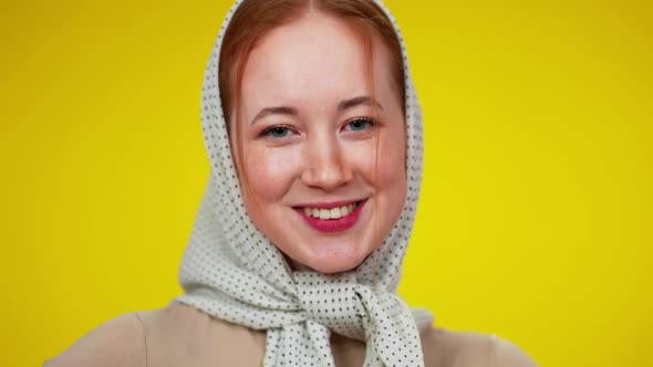 Headshot of Charming Redhead Woman with Green Eyes in Kerchief Looking at Camera Smiling alt