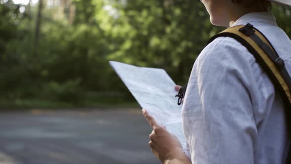 A Tourist Girl Is In The Forest Hiking, Stands Opposite The Sun In A Beautiful Big Hat, Looks alt