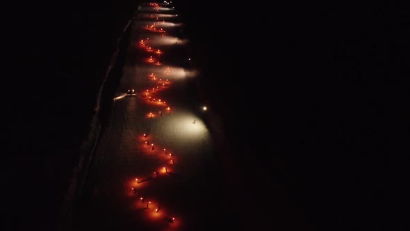 Ski With Torchlights On Slope In Night