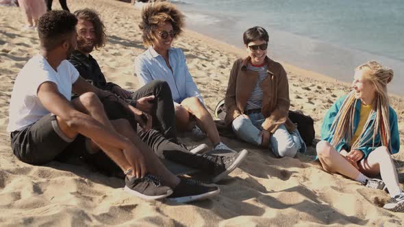 Lounging Happy Friends on Beach alt