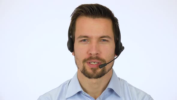 A Young Handsome Call Center Agent Talks To The Camera With A Smile 