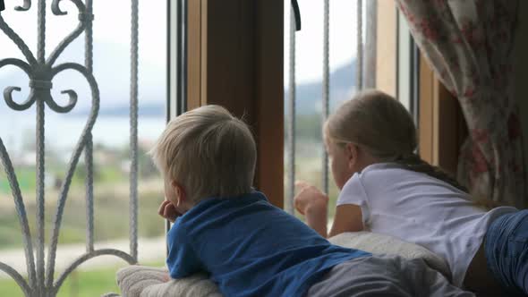 Stay at Home Quarantine Coronavirus Pandemic Prevention, Brother and Sister Looking Out the Window