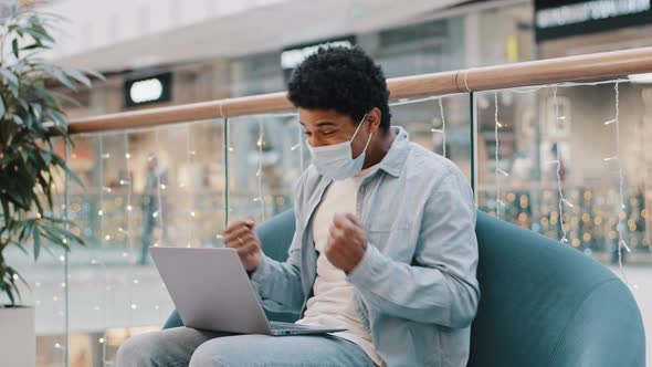 Winner Male Lucky African Guy Man in Medical Protective Mask Win Online Betting Victory Business alt