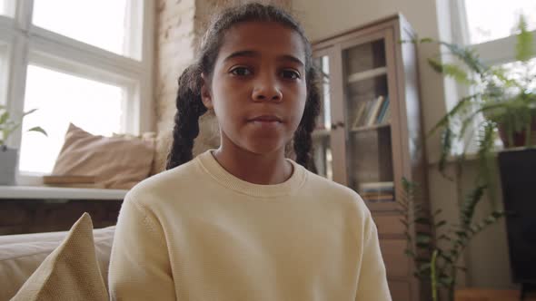 Black Girl Speaking with Teacher via Video Call from Home alt